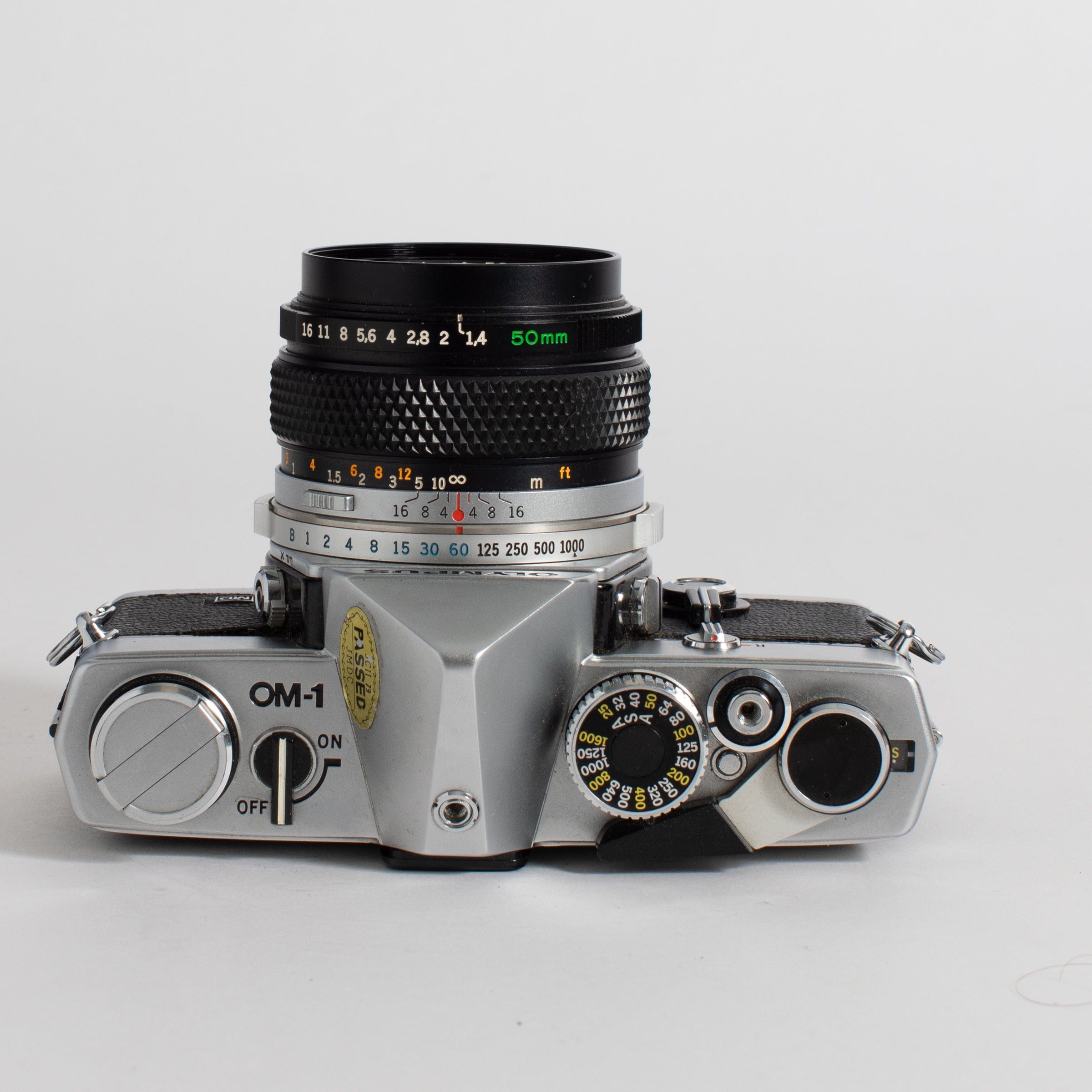 Olympus OM-1 with 50mm f/1.4 lens and leather case (film tested